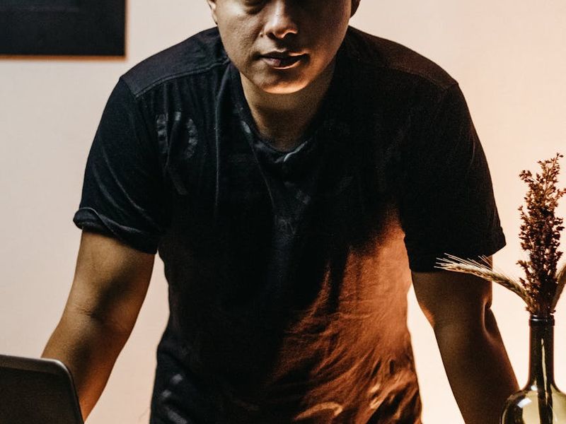 Person focusing on their movement in a dimly lit studio